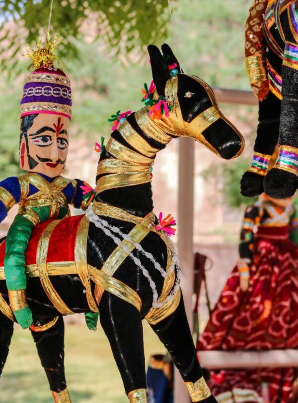 Colorful Rajasthani puppets hanging during fairs and festivals tour