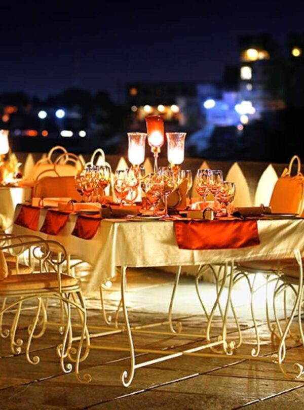 Romantic candlelight dinner setup by Lake Pichola in Udaipur during Rajasthan honeymoon tour